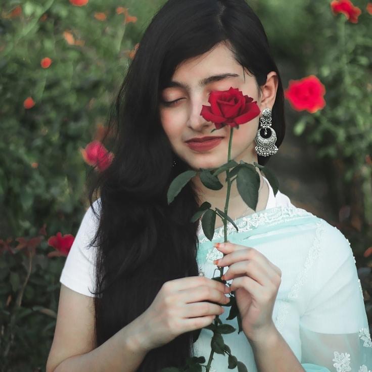 Kaveri Mehta, Lead Design Curator at VistaPulseBridge, reviewing corporate floral arrangements